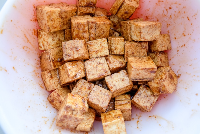 cubes of tofu marinated in sauce in bowl