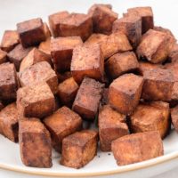 browned tofu pieces in white bowl