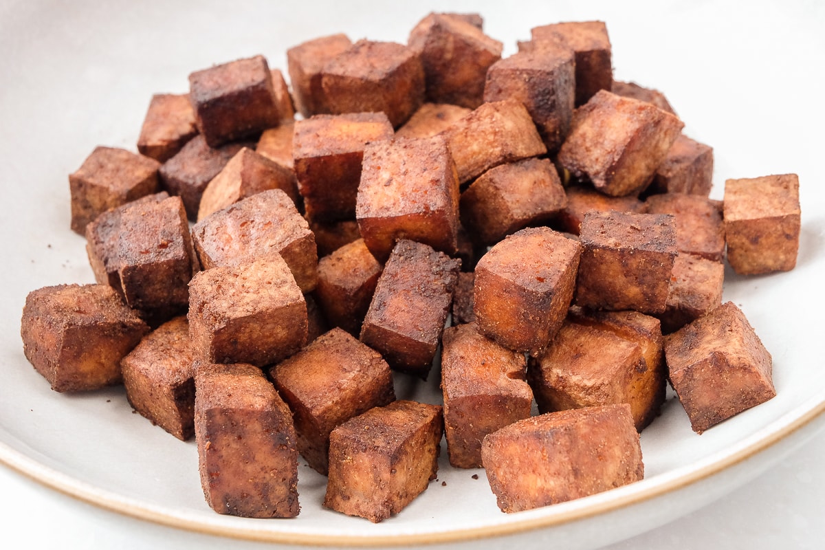browned tofu pieces in white bowl