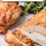 cooked and sliced chicken breast on plate with text overlay "air fryer chicken breast".