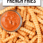 crispy cooked curly fries in bowl with red dipping sauce and text overlay saying "Air fryer frozen french fries"