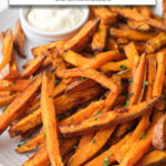 cooked sweet potato fries on plate with mayo and text overlay 