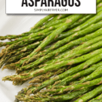 cooked asparagus on white platter with text overlay saying "easy air fryer asparagus"