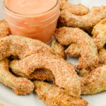breaded avocado fries in bowl with orange dip