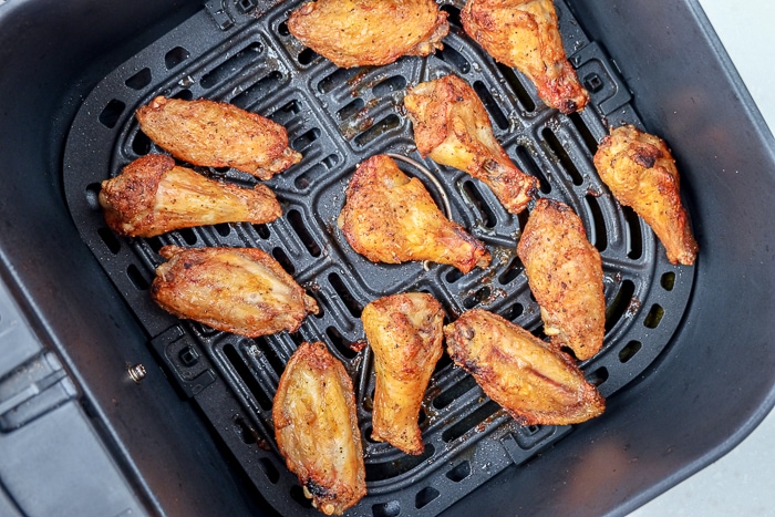 cooked chicken wings in air fryer tray