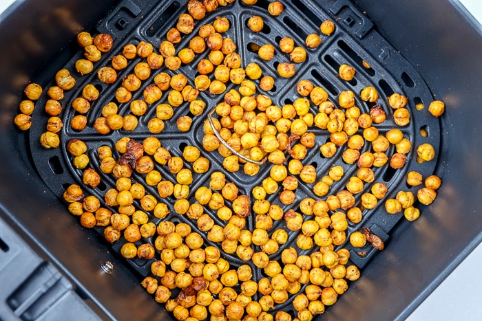 crispy chickpeas in black air fryer basket.