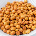 crispy chickpeas in white bowl with towel behind