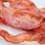 crispy bacon on white plate