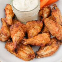 bowl of chicken wings with dip on counter