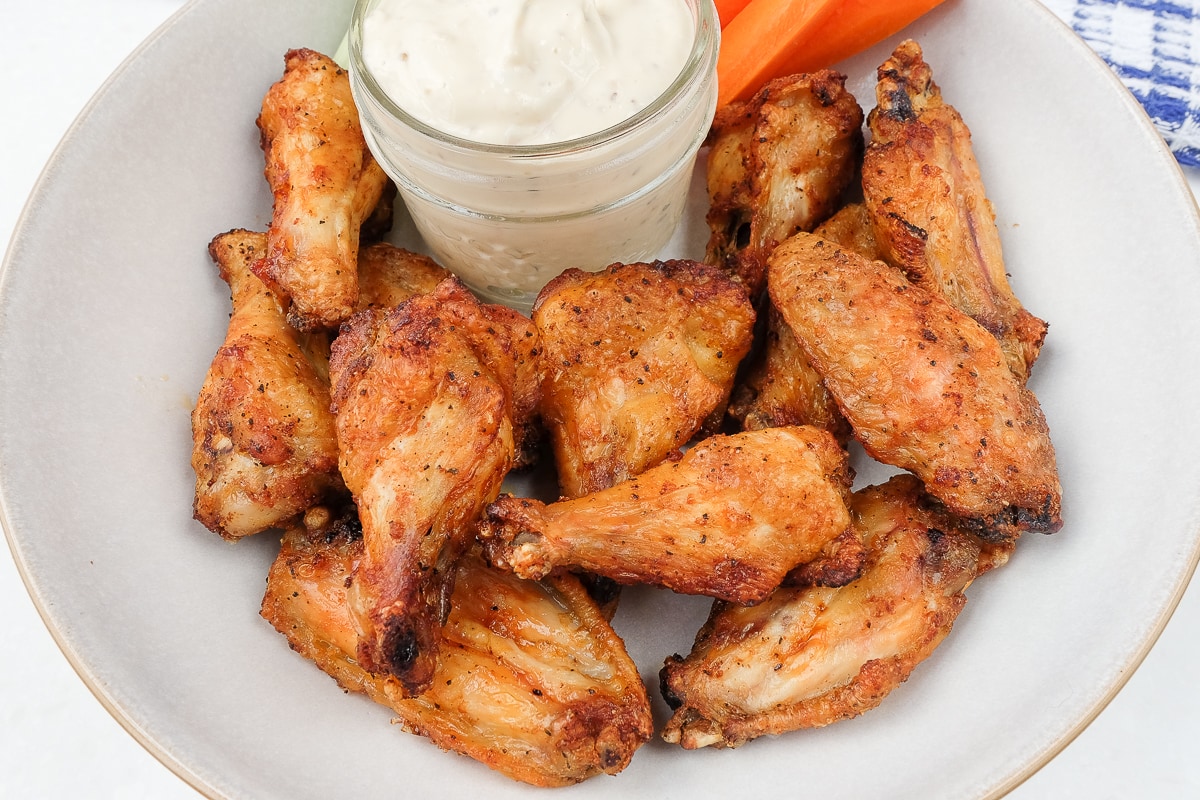 bowl of chicken wings with dip on counter