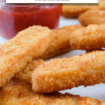 Cooked fish sticks on plate with ketchup in background and text overlay 
