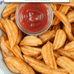cooked potato wedges in bowl with ketchup and text overlay 