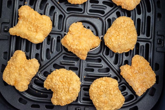 frozen chicken nuggets in black air fryer tray