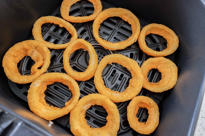 frozen onion rings in black air fryer tray