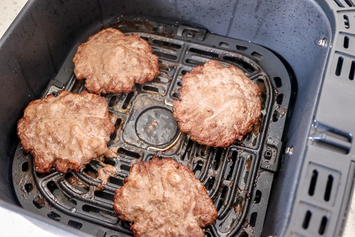 cooked hamburgers in air fryer tray