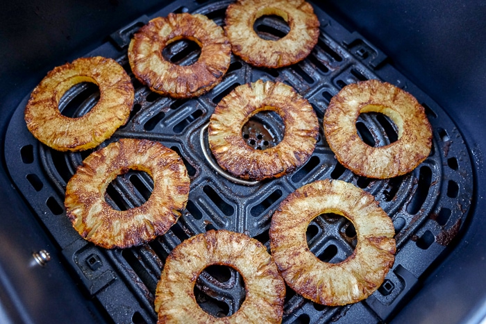 fried pineapple in black air fryer tray