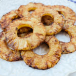 roasted pineapple with cinnamon on floral plate on counter