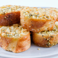 pieces of garlic bread sitting on grey plate