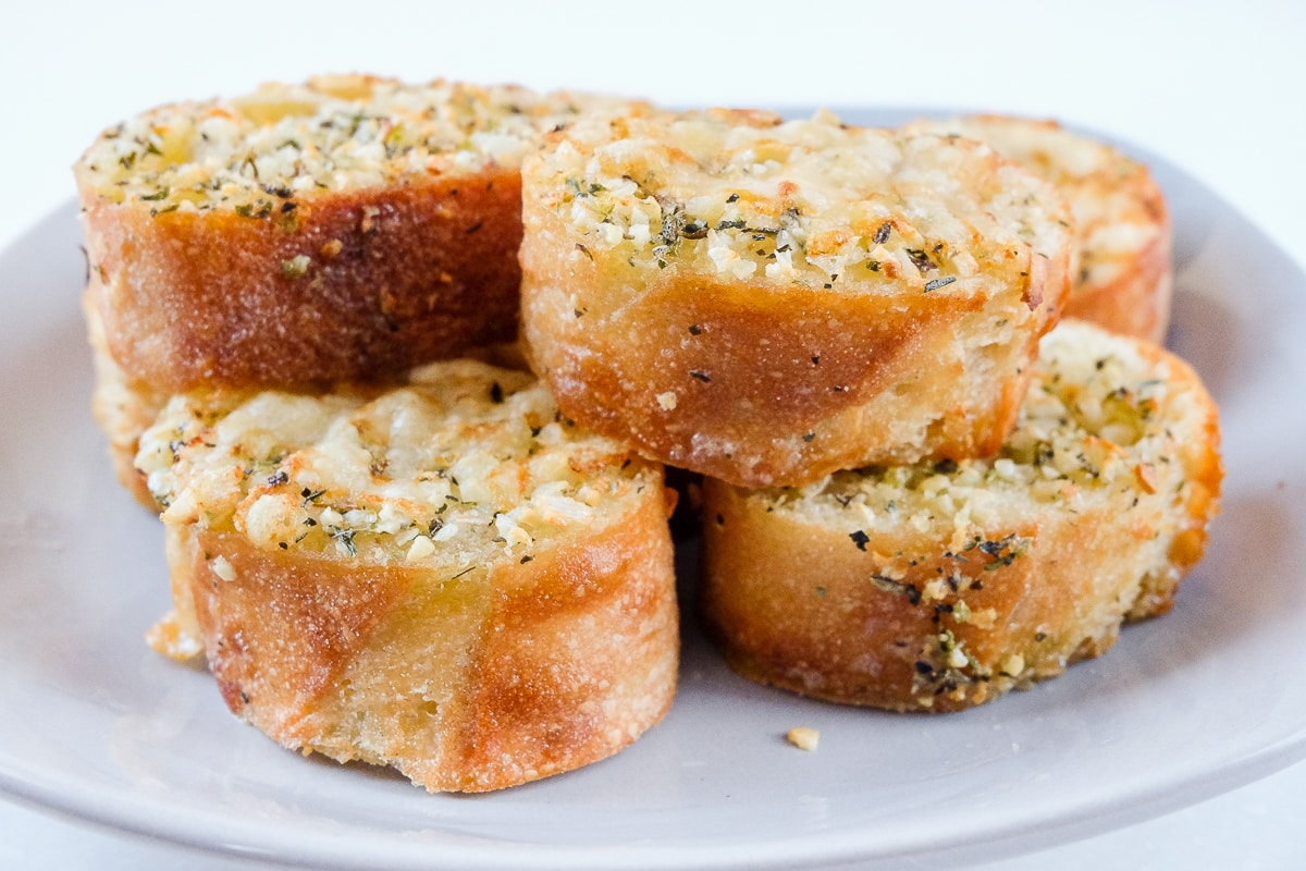 pieces of garlic bread sitting on grey plate