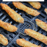 cooked breaded pickle spears in black air fryer with text overlay 