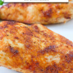 two cooked chicken breasts on plate with text overlay "frozen chicken breast in the air fryer".