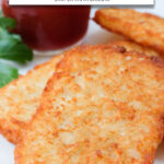 cooked hash brown patties on plate with ketchup and text overlay 