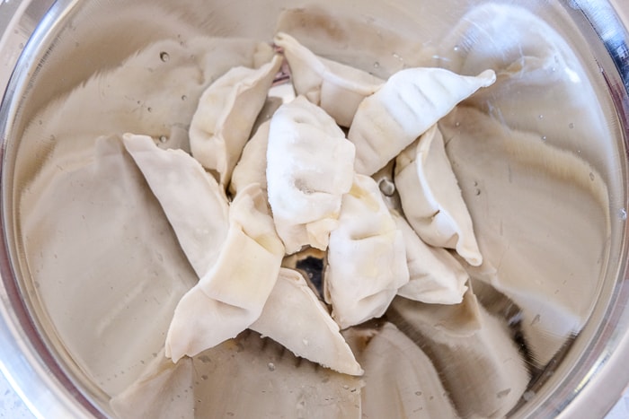 frozen dumplings in silver mixing bowl
