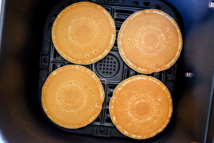 frozen pancakes in black air fryer tray