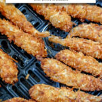 cooked coconut shrimp in black air fryer basket with text overlay "frozen coconut shrimp in the air fryer".