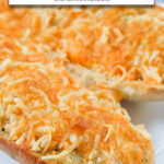 cooked garlic bread with cheese on plate with text overlay "frozen garlic bread in the air fryer".