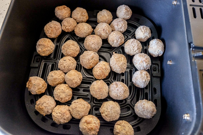 frozen meatballs in black air fryer tray