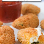 breaded jalapeno poppers on plate with text overlay "air fryer frozen jalapeno poppers".