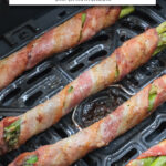 bacon-wrapped asparagus in black air fryer with text overlay 