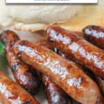 cooked breakfast sausages stacked on white plate with text overlay "breakfast sausages in the air fryer".