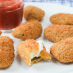jalapeno poppers on plate with bite out of it