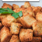 crispy croutons in bowl with text overlay "croutons in the air fryer".