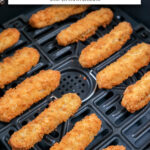 breaded chicken fries in black air fryer with text overlay "frozen chicken fries in the air fryer".