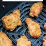 chicken wings in black air fryer with text overlay "frozen wings in the air fryer".
