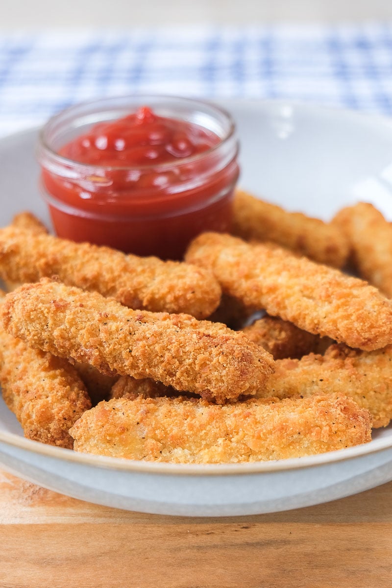 crispy chicken fries in bowl with ketchup for dipping behind