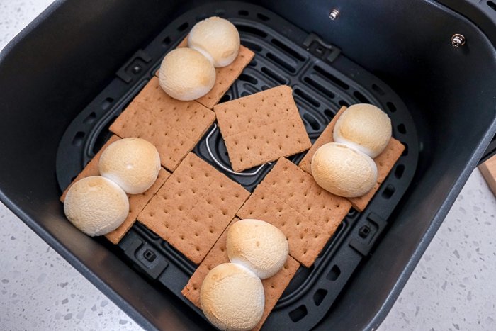 toasted marshmallows and graham crackers in black air fryer tray