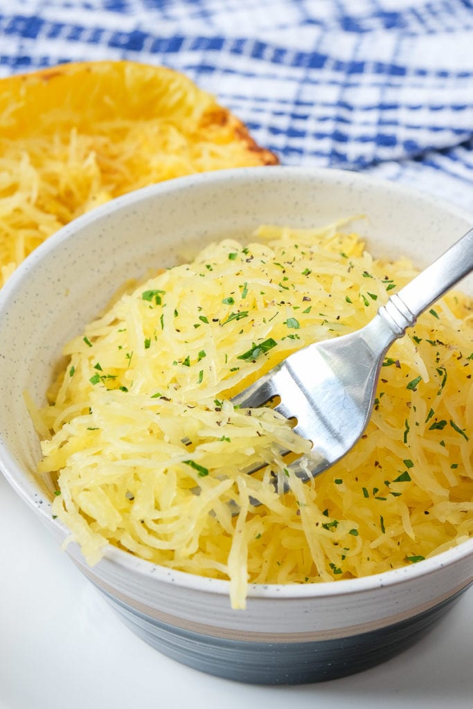 spaghetti squash in bowl lifted with silver fork