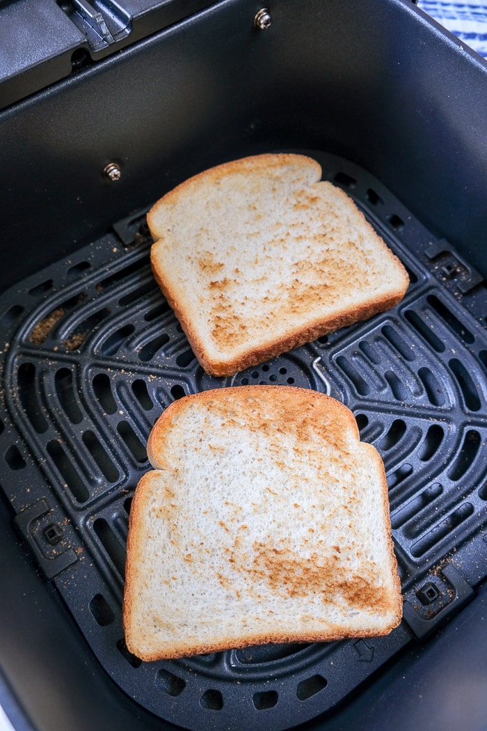 crispy pieces of toast in black air fryer tray