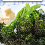 broccolini stacked on white plate with text overlay 