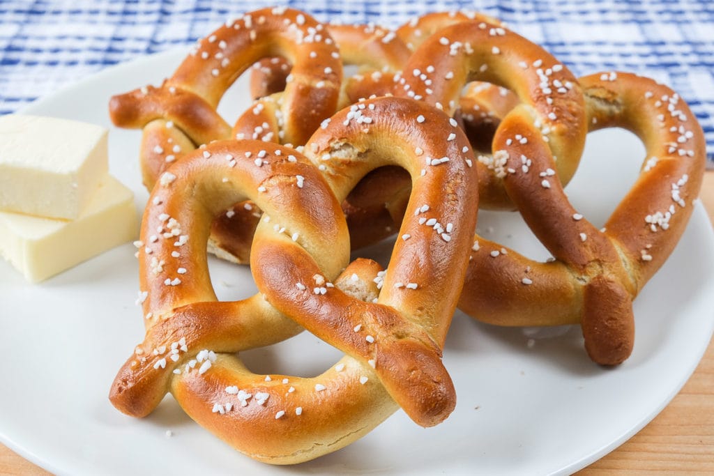 soft pretzels with salt and butter on white plate