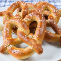 soft pretzels with salt and butter on white plate