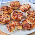 bagel bites on white plate on wooden board