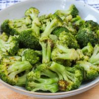 bowl of green broccoli on wooden board