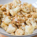 cooked cauliflower on bowl on wooden board