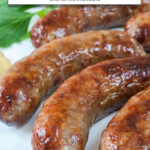 cooked bratwurst on white plate with text overlay "juicy brats in the air fryer".