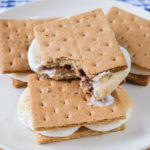 toasted smores on white plate on wooden board